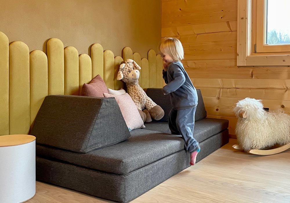 A customer photo of a child playing on Monboxy play couch set