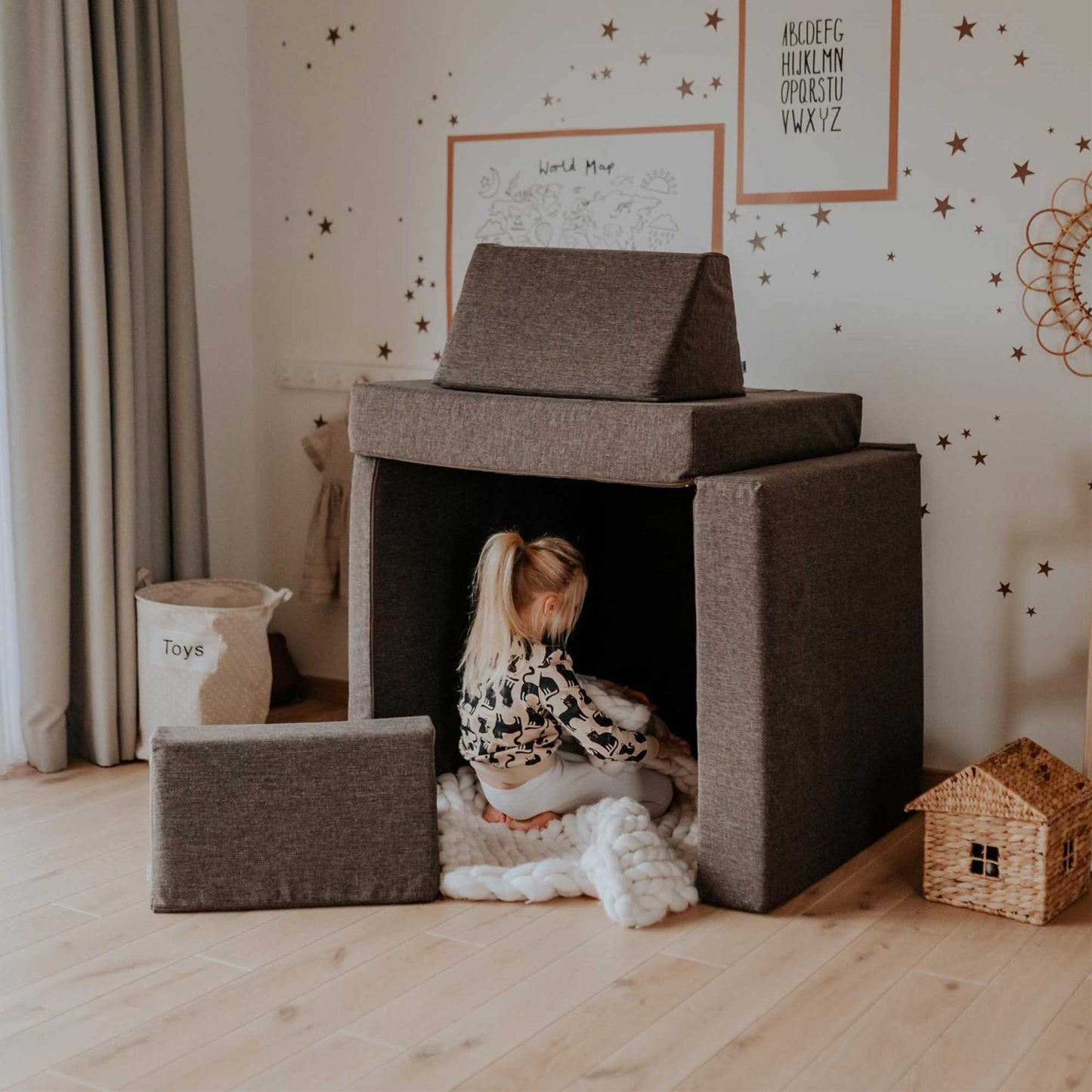 Foam mattress set put as a play house and a girl playing inside it