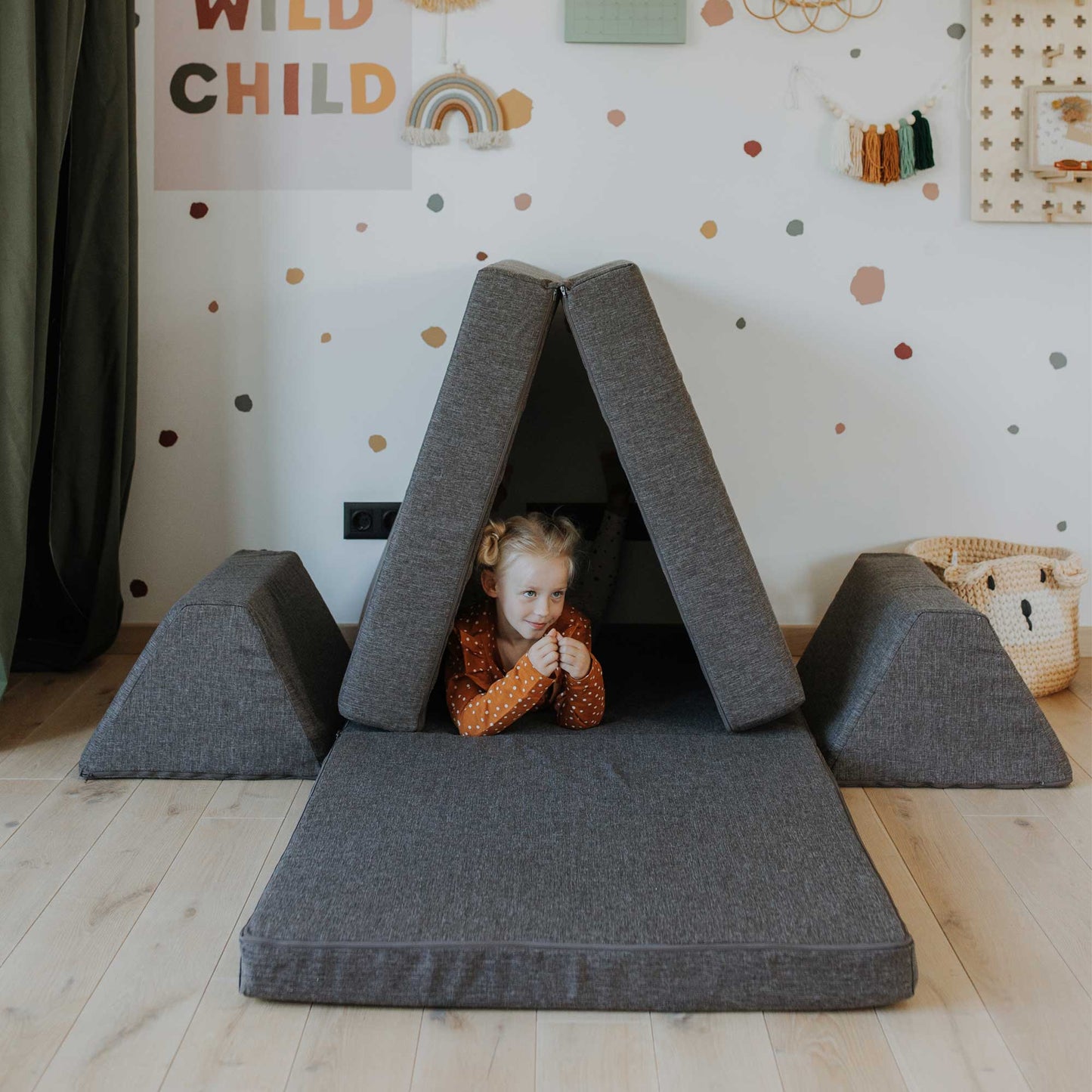 Foam mattress play set puta as a tent and a girl playing inside it