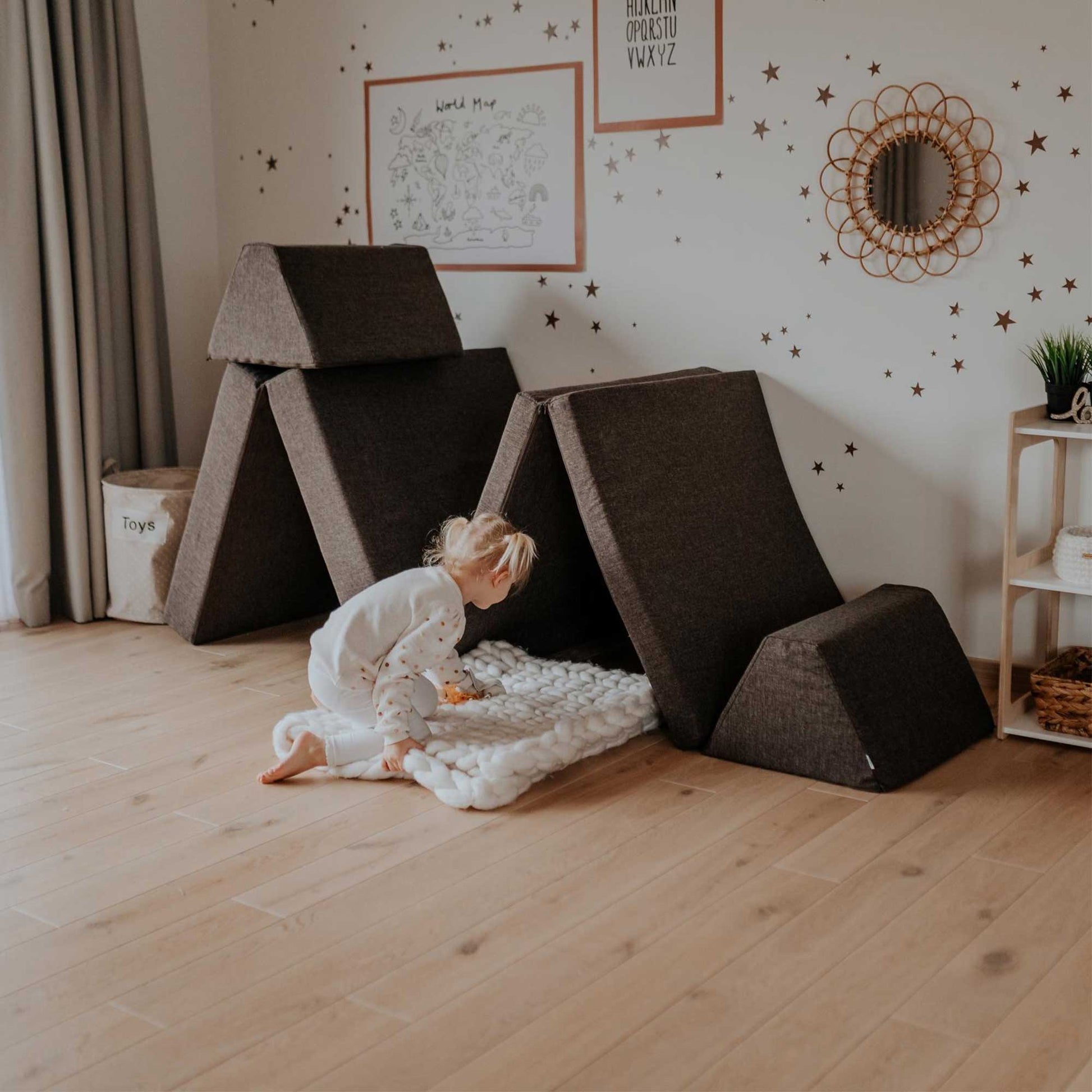 A girl playing in her room with a dark brown Monboxy play sofa set