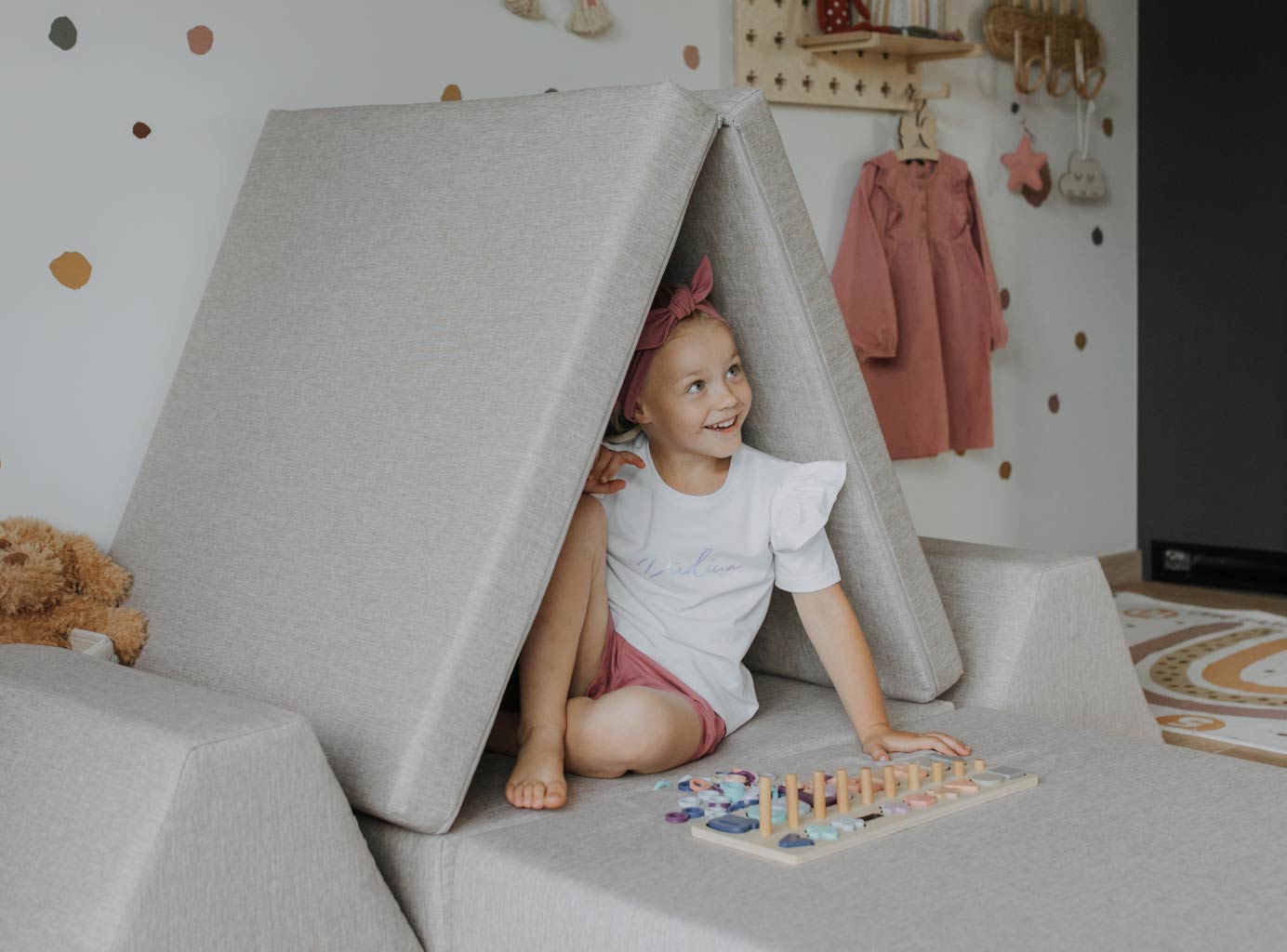 A girl playing in a Monboxy fort