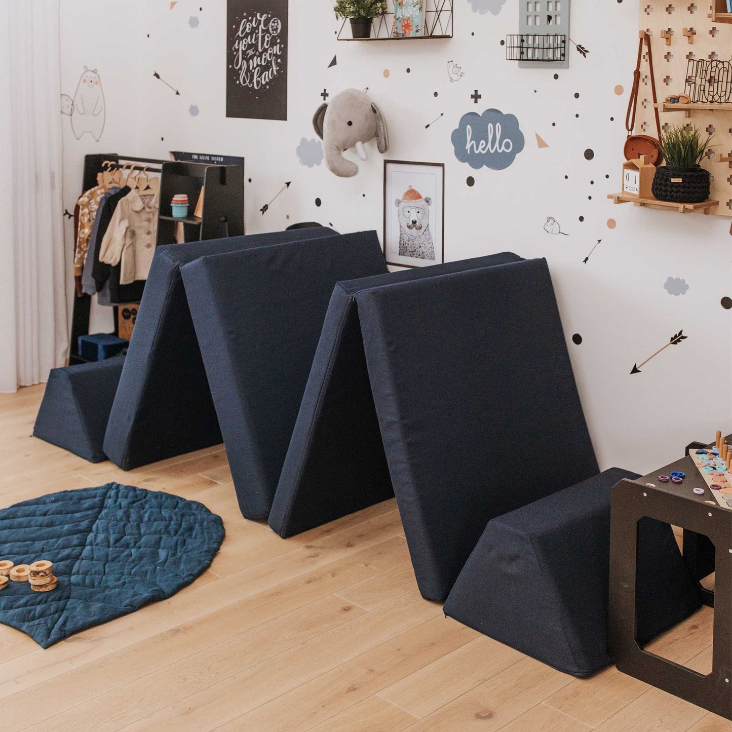 A navy blue Monboxy foam mattress set built into a shape of a double wigwam