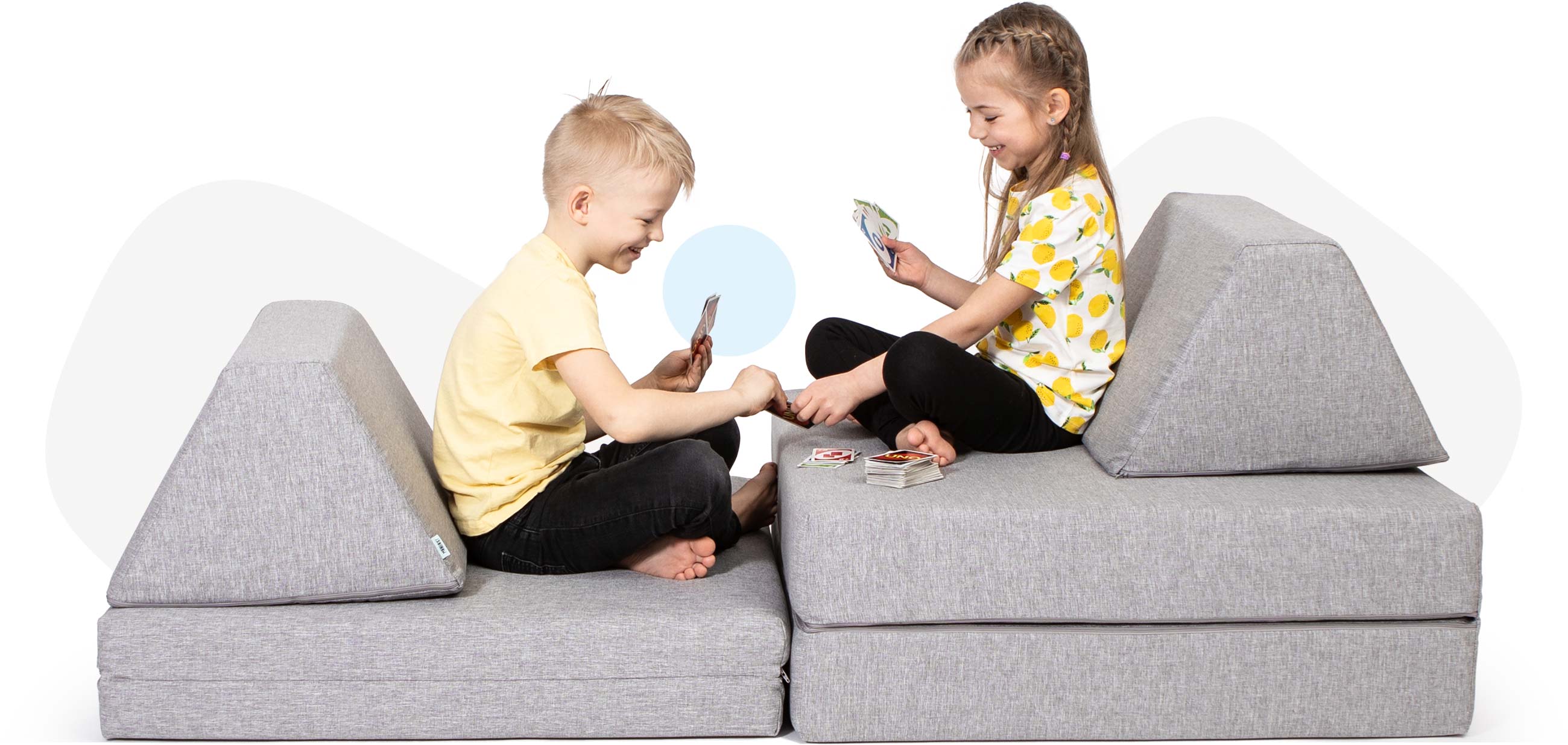 Kids sitting and playing cards on a grey Monboxy toddler couch set