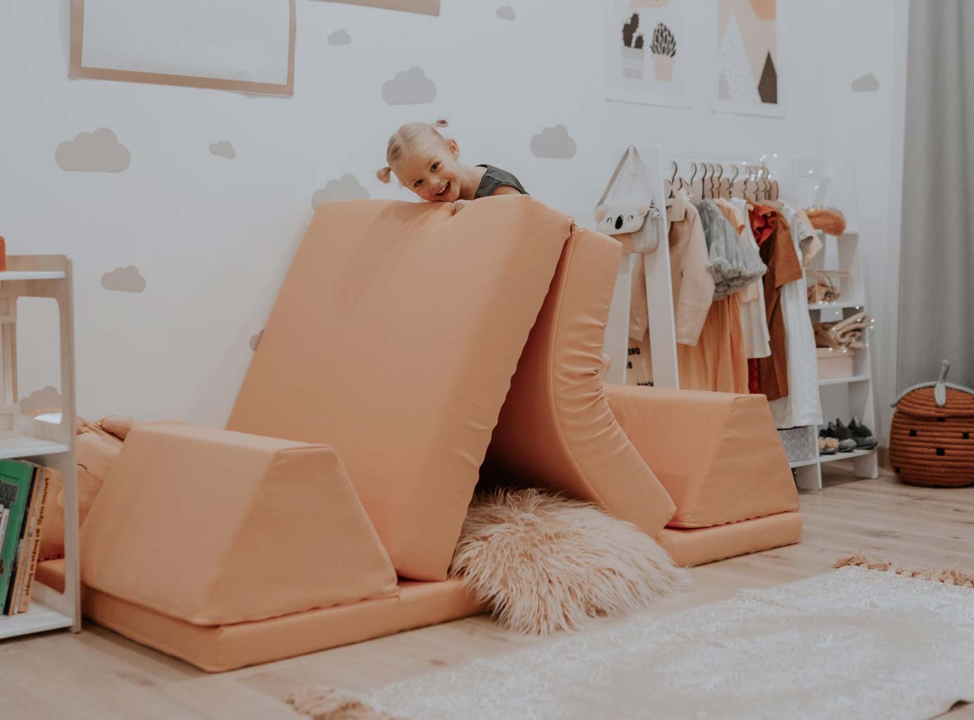 Kid playing on the pink play sofa set