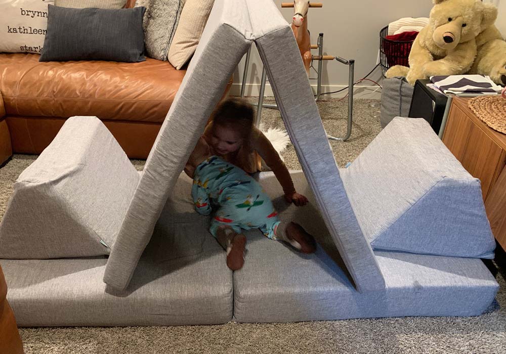 A baby and a toddler playing with their grey Monboxy sofa set
