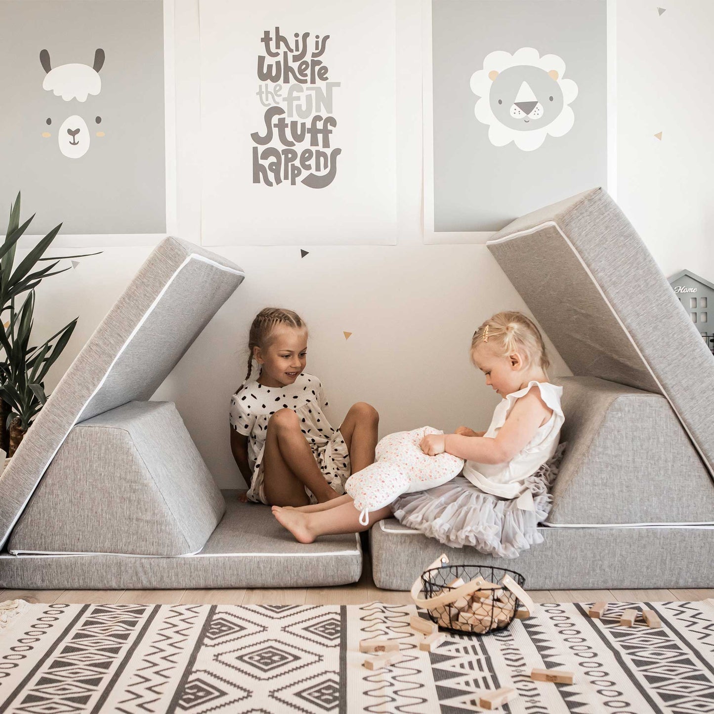 Two girls playing inside a grey Monboxy play couch 
