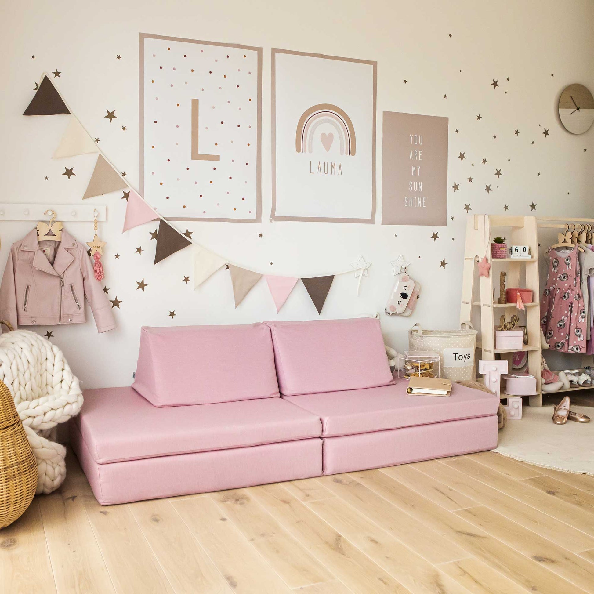 A pink Monboxy activity sofa in a girl's bedroom