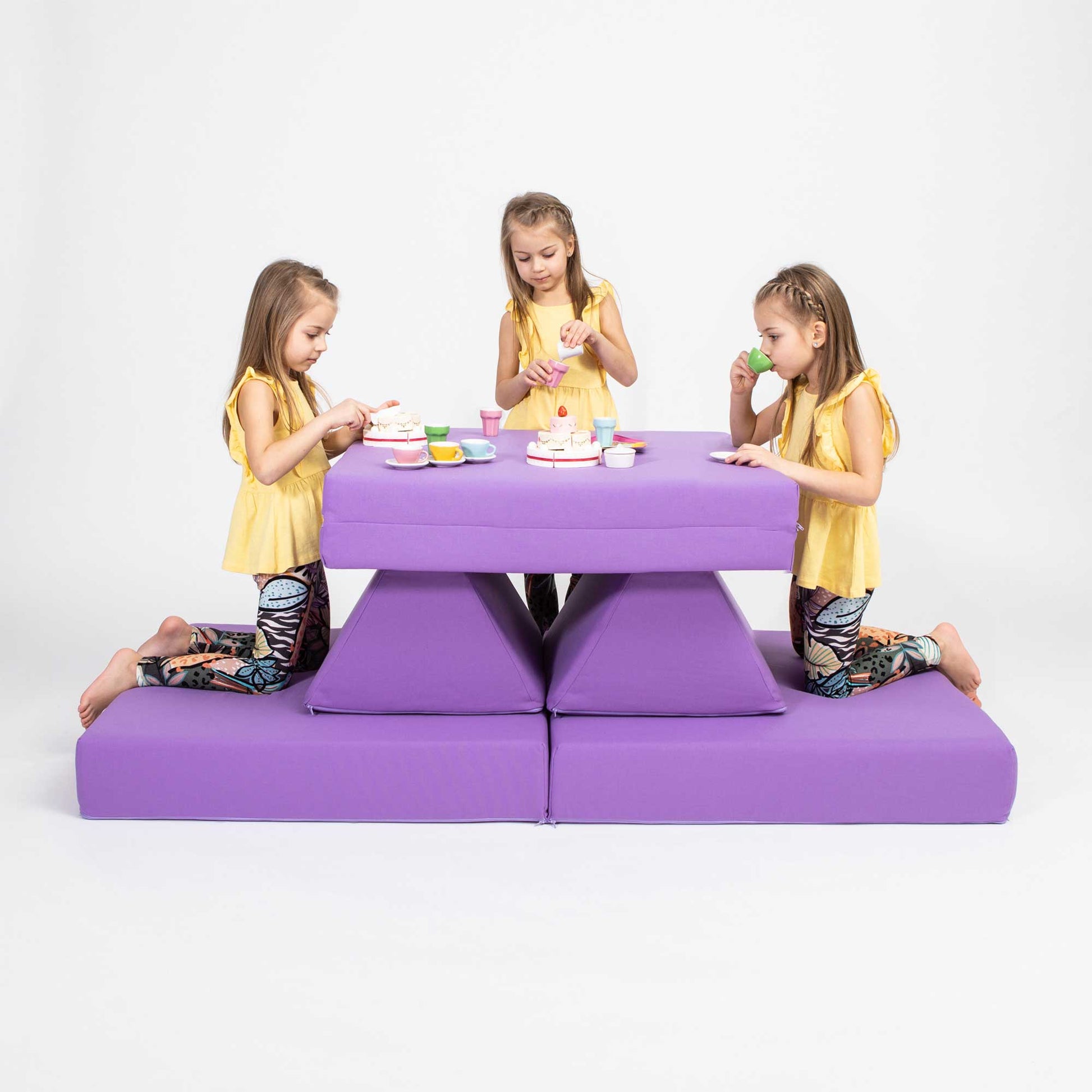 Three girls playing tea time on a purple Monboxy activity mat