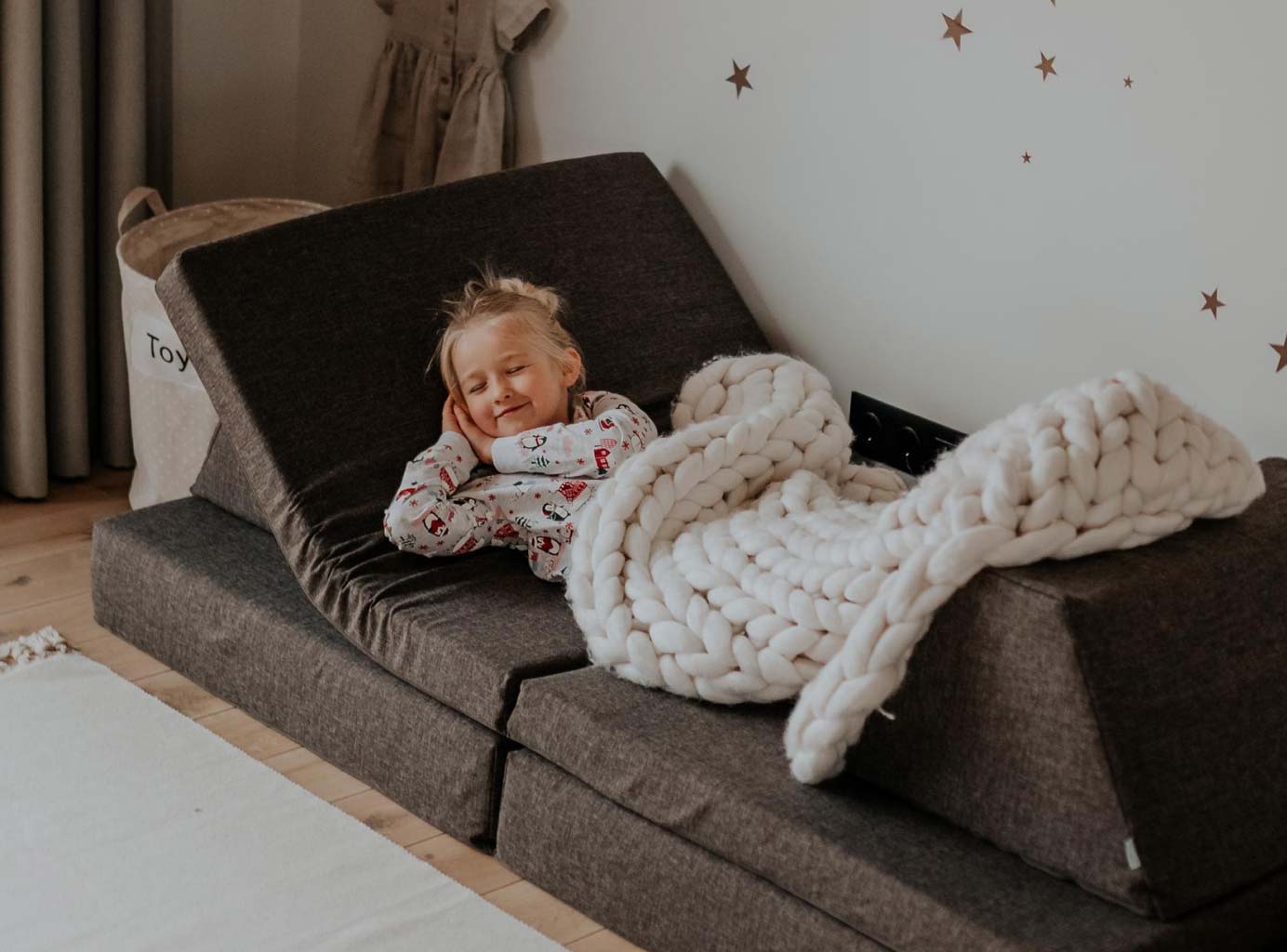 A girl sleeping on a brown Monboxy play sofa set