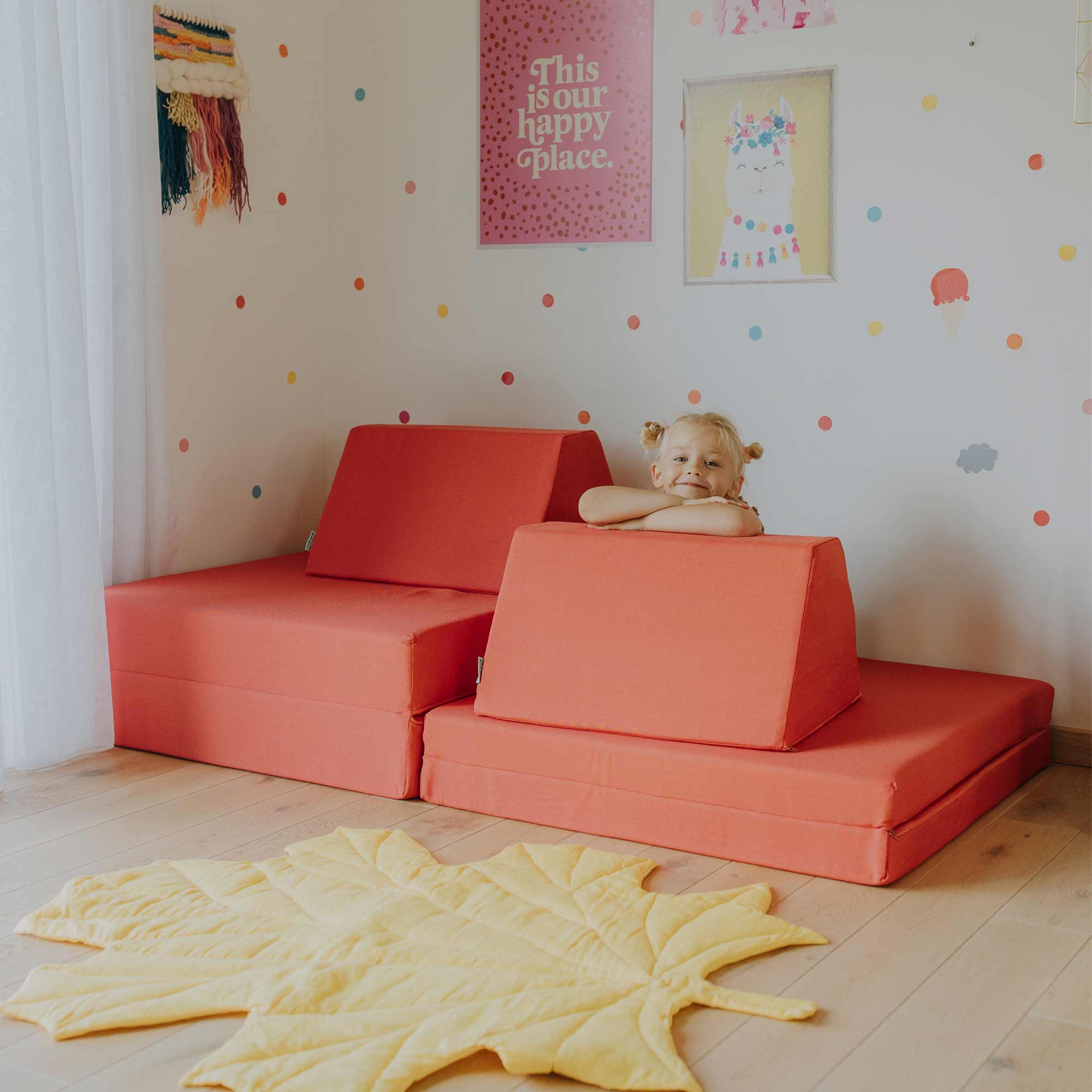 A girl playing on the Monboxy coral play sofa set